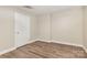 Bedroom with wood-look flooring, drop ceiling, and white door at 6655 Maple Spring Ct, Denver, NC 28037