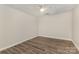 Bedroom with wood-look flooring, drop ceiling, and a ceiling fan at 6655 Maple Spring Ct, Denver, NC 28037