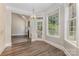Bright breakfast nook with hardwood floors, natural light, and fireplace views at 6655 Maple Spring Ct, Denver, NC 28037