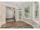 Bright dining room with hardwood floors, fireplace, and abundant natural light from the windows and glass door at 6655 Maple Spring Ct, Denver, NC 28037