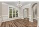 Well-lit dining room featuring hardwood floors, a chandelier, and large windows at 6655 Maple Spring Ct, Denver, NC 28037