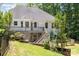 View of the back of the home with a deck, stairs and fenced yard at 6655 Maple Spring Ct, Denver, NC 28037