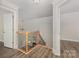 Well-lit landing with hardwood floors, neutral walls, staircase with wooden banister and wrought-iron spindles at 6655 Maple Spring Ct, Denver, NC 28037