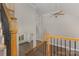 Foyer with hardwood floors, neutral walls, white trim and staircase with wooden banister and wrought-iron spindles at 6655 Maple Spring Ct, Denver, NC 28037