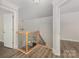 Well-lit landing with hardwood floors, neutral walls, staircase with wooden banister and wrought-iron spindles at 6655 Maple Spring Ct, Denver, NC 28037