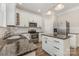 Updated kitchen with granite counters, stainless steel appliances, and white cabinets at 6655 Maple Spring Ct, Denver, NC 28037