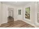 Living room with hardwood floors, white trim, bright windows and outdoor access at 6655 Maple Spring Ct, Denver, NC 28037
