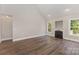 Neutral living room showcases hardwood floors, fireplace, and plenty of natural light at 6655 Maple Spring Ct, Denver, NC 28037