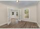 Living room with hardwood floors, white trim, bright windows and outdoor access at 6655 Maple Spring Ct, Denver, NC 28037