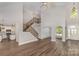 Bright, open living room with soaring ceilings, hardwood floors, and elegant staircase at 6655 Maple Spring Ct, Denver, NC 28037
