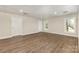 A clean room with luxury vinyl plank flooring, white trim, two windows and two painted doors at 6655 Maple Spring Ct, Denver, NC 28037