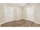 A clean room with luxury vinyl plank flooring and two white painted doors at 6655 Maple Spring Ct, Denver, NC 28037