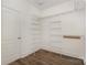 This walk-in closet offers plenty of storage with shelves and laminate flooring at 6655 Maple Spring Ct, Denver, NC 28037