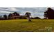 Sprawling one-story home surrounded by green, open fields, offering a peaceful and picturesque setting at 6714 Old Shelby Rd, Vale, NC 28168