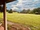 Inviting exterior view highlighting a wide, open lawn and a glimpse of the beautiful surroundings at 6714 Old Shelby Rd, Vale, NC 28168