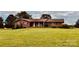 Well-maintained brick house with a sprawling front yard and a welcoming covered entryway at 6714 Old Shelby Rd, Vale, NC 28168