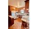 Classic kitchen with wood cabinetry, white appliances, and breakfast bar, ready for updates at 6714 Old Shelby Rd, Vale, NC 28168