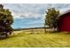 Scenic view of a green pasture with a rustic fence and a glimpse of distant mountains at 6714 Old Shelby Rd, Vale, NC 28168
