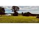 Expansive green lawn features barn, house, and shed under a cloudy sky, showcasing a rural estate at 6714 Old Shelby Rd, Vale, NC 28168