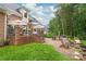 Expansive backyard showcases a brick patio, an outdoor kitchen, and lush landscaping perfect for entertaining at 7018 Dowington Dr, Charlotte, NC 28277