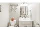 Modern bathroom with floating vanity, farmhouse sink, and stylish lighting fixture at 7018 Dowington Dr, Charlotte, NC 28277