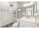 Updated bathroom with white marble, modern fixtures, and glass shower at 7018 Dowington Dr, Charlotte, NC 28277