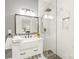 This modern bathroom offers white marble, a glass shower, and an open, airy feel at 7018 Dowington Dr, Charlotte, NC 28277