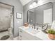 Chic gray bathroom features white marble countertops, a glass shower, and modern fixtures at 7018 Dowington Dr, Charlotte, NC 28277