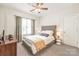 Bright bedroom with ceiling fan, neutral color scheme, carpeted floor, and well-lit ambiance at 7018 Dowington Dr, Charlotte, NC 28277