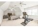 Spacious bonus room with gym equipment, ample seating, and lots of natural light at 7018 Dowington Dr, Charlotte, NC 28277