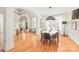 Elegant dining room with hardwood floors, large windows, and modern lighting fixtures, perfect for entertaining at 7018 Dowington Dr, Charlotte, NC 28277