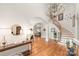 Spacious foyer featuring a curved staircase, hardwood floors, and stylish decor, creating an inviting atmosphere at 7018 Dowington Dr, Charlotte, NC 28277