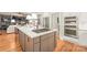 Gourmet kitchen with stainless steel appliances, island cooktop, and seamless transition to living area at 7018 Dowington Dr, Charlotte, NC 28277