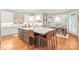 Island kitchen with quartz countertop, stainless steel appliances, and adjacent dining area with natural light at 7018 Dowington Dr, Charlotte, NC 28277