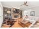 Inviting living room featuring a stone fireplace, built-in shelving, hardwood floors, and comfortable seating at 7018 Dowington Dr, Charlotte, NC 28277