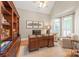 Cozy office with vaulted ceilings, natural light, custom built-ins, and comfortable seating at 7018 Dowington Dr, Charlotte, NC 28277