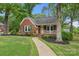 Charming brick home with a welcoming front porch and well-manicured landscaping at 725 W Graham St, Shelby, NC 28150