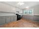 Bright kitchen featuring gray cabinets, tile backsplash, modern appliances, and ample natural light at 725 W Graham St, Shelby, NC 28150