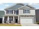 Two-story home showcasing stone accents, vertical siding, gray shingles and a two-car garage at 7909 Old Brook Rd, Sherrills Ford, NC 28673