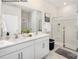 Bathroom featuring a double vanity with white cabinets, a large mirror, and a glass-enclosed shower at 7913 Old Brook Dr, Sherrills Ford, NC 28673
