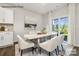 Elegant dining area with modern furnishings and natural light streaming through sliding glass doors at 7913 Old Brook Dr, Sherrills Ford, NC 28673