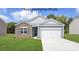 Charming single-Gathering home with stone accents, a two-car garage, and lush green lawn at 7913 Old Brook Dr, Sherrills Ford, NC 28673