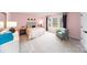 Charming pink bedroom featuring a patterned bedspread and a comfortable sitting area at 8004 Plymouth Dr, Sherrills Ford, NC 28673
