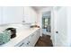 Bright butler pantry with white cabinets and countertops connecting to the dining room at 8004 Plymouth Dr, Sherrills Ford, NC 28673