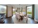 Elegant dining room with hardwood floors, large windows, and a modern table setting at 8004 Plymouth Dr, Sherrills Ford, NC 28673