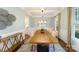 Formal dining room with elegant details, featuring a long wood table, neutral decor, and large windows at 8004 Plymouth Dr, Sherrills Ford, NC 28673