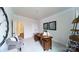 Well-lit office with a large wooden desk, model sailboat, and a view of a hallway at 8004 Plymouth Dr, Sherrills Ford, NC 28673