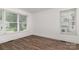 Bedroom featuring wood-look floors and natural light from the windows at 8429 Meadowcroft Ct, Charlotte, NC 28215
