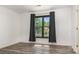 Bedroom with a large window and dark colored curtain at 8429 Meadowcroft Ct, Charlotte, NC 28215