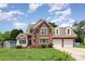 Beautiful two-story brick home with well-maintained lawn and a two-car attached garage at 8429 Meadowcroft Ct, Charlotte, NC 28215